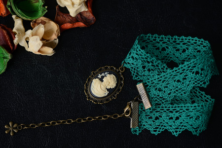 Choker necklace with girl cameo pendant on a dark background close upの写真素材