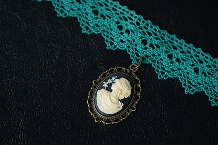 Choker necklace with girl cameo pendant on a dark background close upの写真素材
