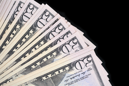 A pack of fifty dollar bills on a dark background