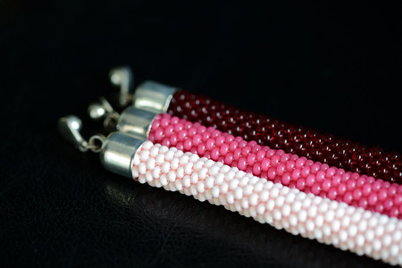 Set of three beaded bracelets on a dark background close upの写真素材