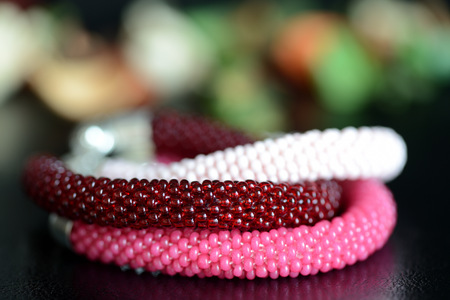 Set of three beaded bracelets on a dark background close upの写真素材