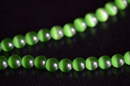 Green stone necklace on a dark background close upの写真素材