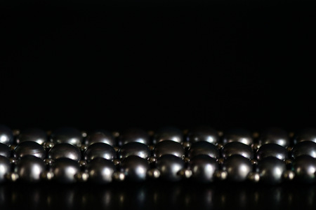 Black pearl necklace on a dark background close upの写真素材