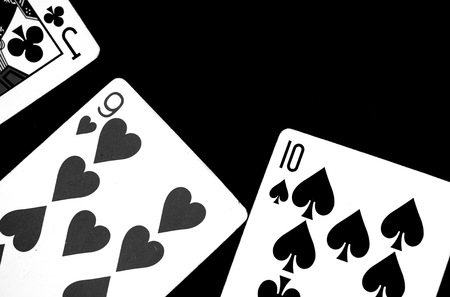 Playing cards on a dark surface close up. Black and whiteの写真素材