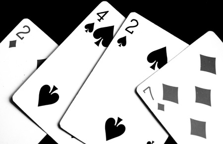 Playing cards on a dark surface close up. Black and white