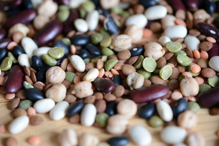 Mix of different beans on wooden background close upの写真素材