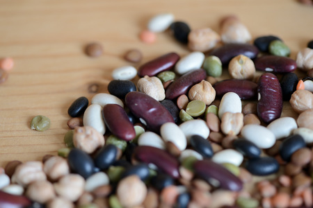 Mix of different beans on wooden background close upの写真素材
