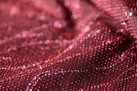 Red textile background with sparkles close upの写真素材