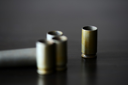 Empty old bullet cartridges on a dark background close upの写真素材