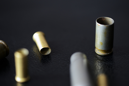 Empty old bullet cartridges on a dark background close upの写真素材