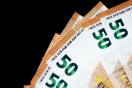 Fifty euro banknotes on a dark background close up