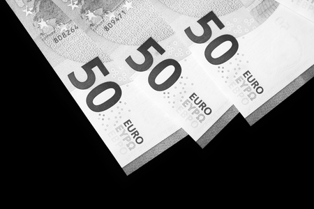 Fifty euro banknotes on a dark background close up. Black and white