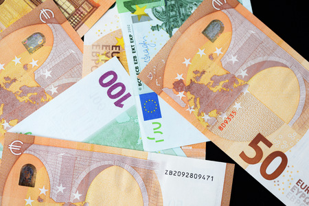 One Hundred and Fifty euro banknotes on a dark background close upの写真素材