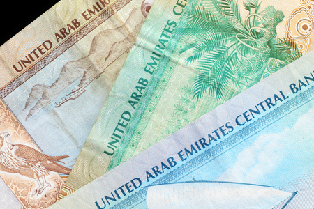 UAE dirham currency notes on a dark background close upの写真素材