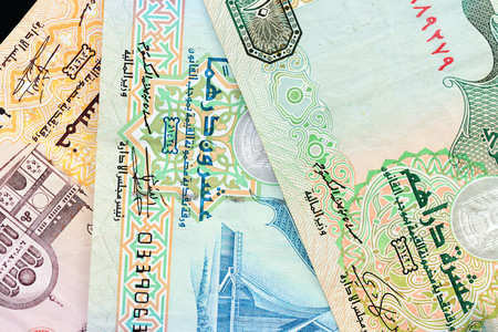 UAE dirham currency notes on a dark background close up
