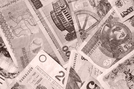 Different countries money background close up. Brown color toned