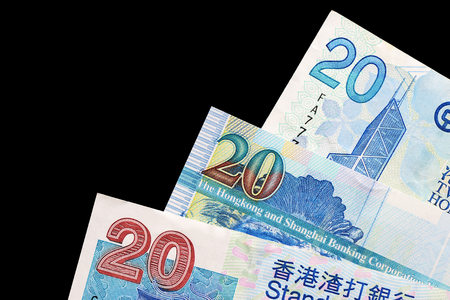 Three different bills in twenty Hong Kong dollars on a dark background close upの写真素材