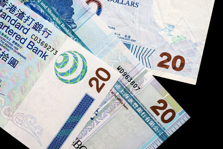 Three different bills in twenty Hong Kong dollars on a dark background close upの写真素材
