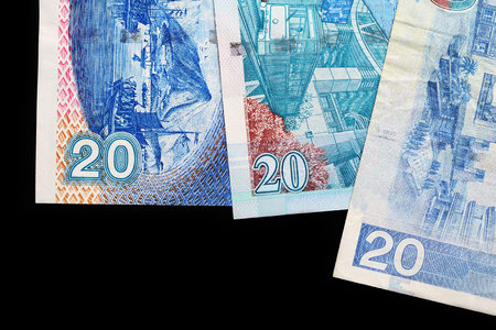 Three different bills in twenty Hong Kong dollars on a dark background close upの写真素材