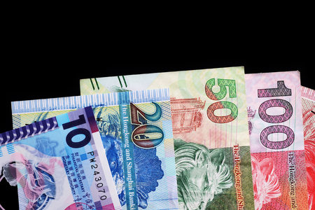 Hong Kong dollars bills on a dark background close up