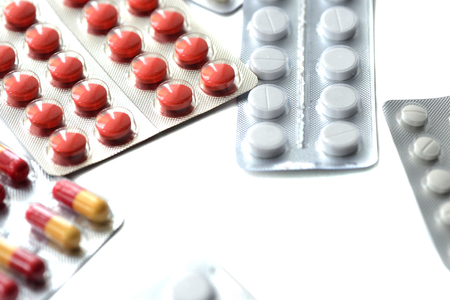 Packages with pills and tablets on white background close upの写真素材