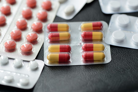 Pills and tablets packages  on a dark background close up