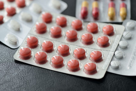 Pills and tablets packages  on a dark background close up