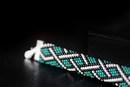 Celtic print emerald color bracelet on a dark background close upの写真素材