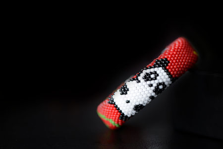 Red bracelet with funny panda on a dark background close upの写真素材