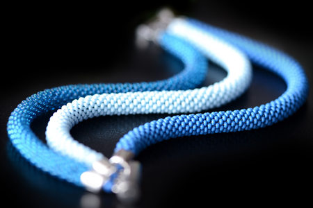 Blue bead crochet bracelet on a dark background close upの写真素材