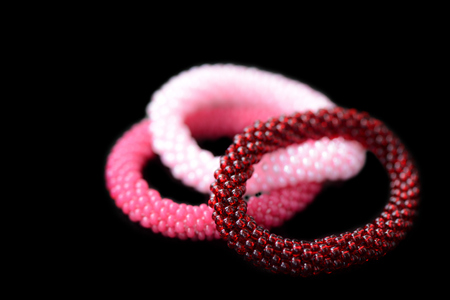 Set of three kids bracelets isolated on a black background close upの写真素材