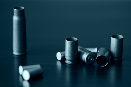 Empty old bullet cartridges close up. Blue color toned