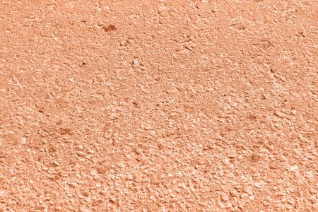 Old asphalt surface texture close up. Orange color toned backgroundの写真素材