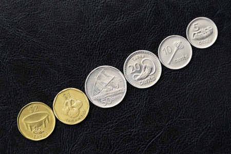 Several coins from Fiji on a dark background close upの写真素材
