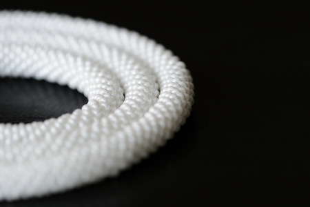 White long beaded necklace on a dark backgroun close upの写真素材