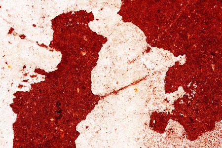 Old asphalt surface painted with white paint red color toned close up. Abstract backgroundの写真素材