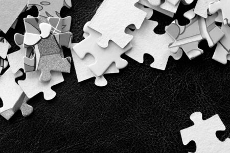 Children's puzzles on a dark background close up. Black and whiteの写真素材