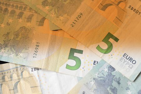 Five euro banknotes close up. Money background brown color tonedの写真素材