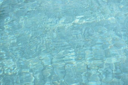 Water surface in a swimming pool. Blurred abstract background