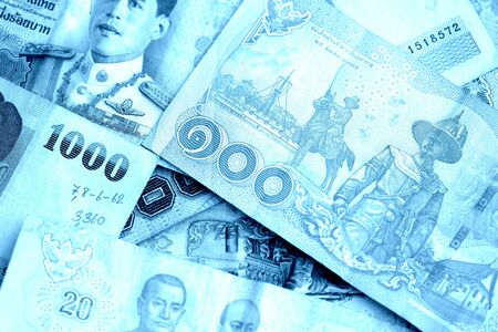Various banknotes thai baht close up. Money background blue color tonedの写真素材