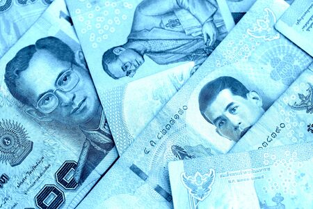 Various banknotes thai baht close up. Money background blue color tonedの写真素材
