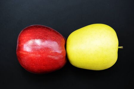 Red and yellow apples on a dark background close-upの写真素材
