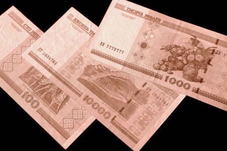 Outdated Belarusian rubles on black background close up brown color tonedの写真素材