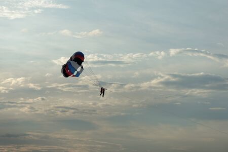 Parasailing on the background of the evening sky. Water activities on the coast of Vietnamの写真素材