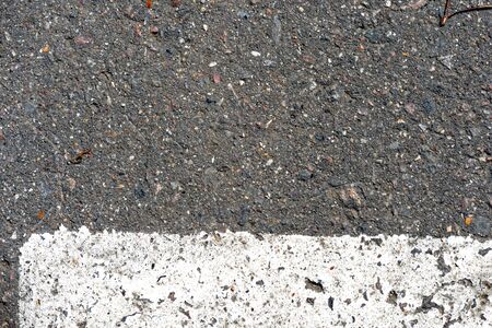 Old dirty asphalt texture with white paint on it. Top viewの写真素材