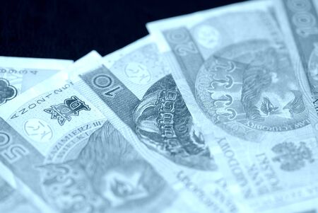 Several banknotes of Polish zloty blue color toned close upの写真素材