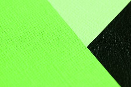 Different color cardboard sheets on a dark leather surface close up. Abstract backgroundの写真素材