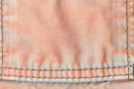 Orange color old denim texture close up. Textile backgroundの写真素材