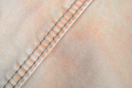 Orange color old denim texture close up. Textile backgroundの写真素材