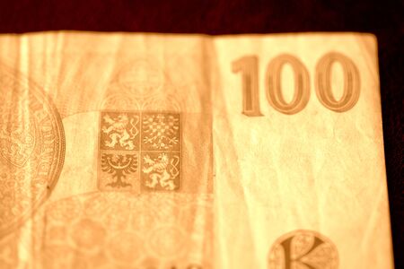 One hundred Czech crown banknote on a dark background close up. Brown color tonedの写真素材